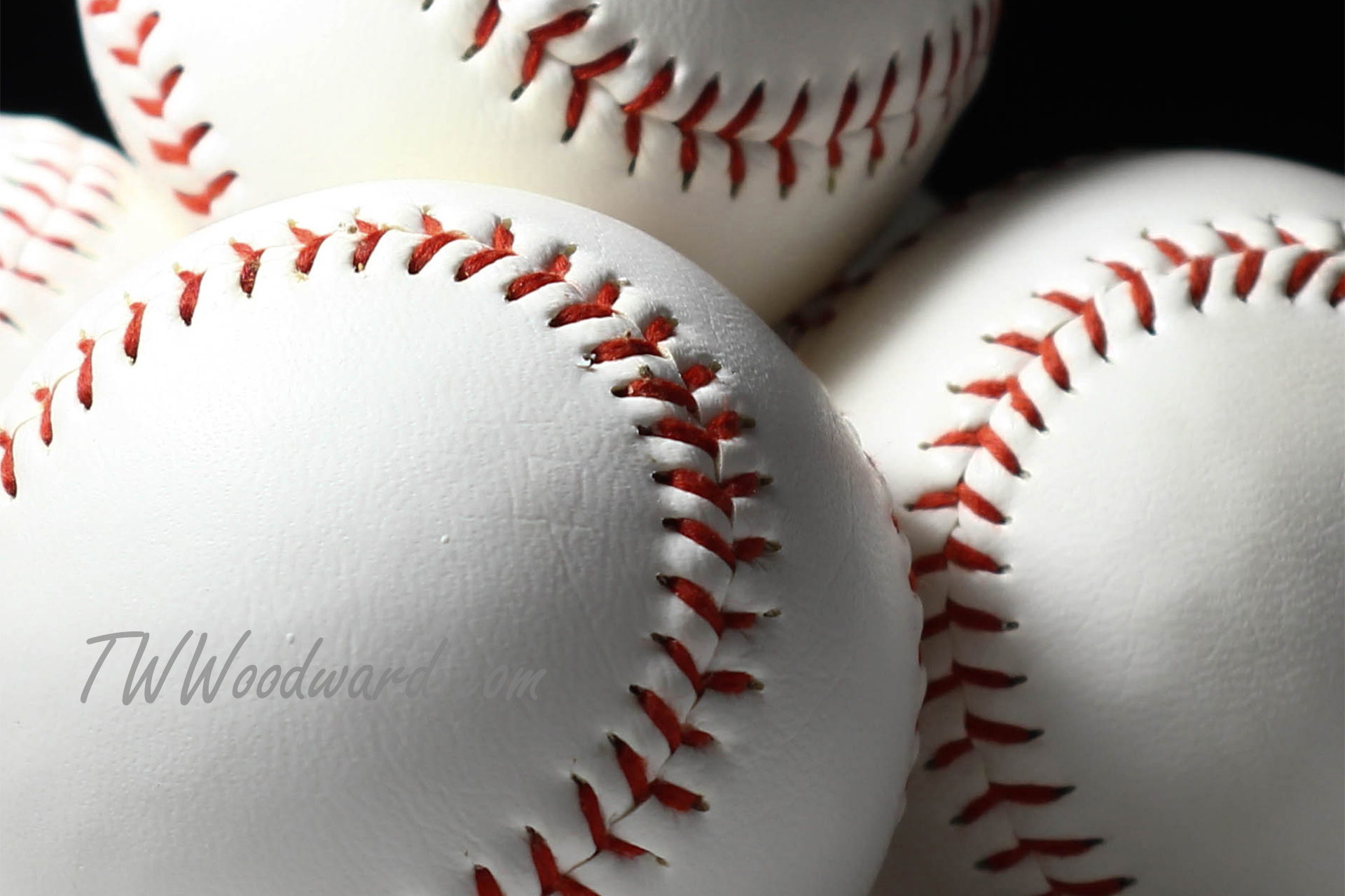 Pitcher mid-throw under stadium lights