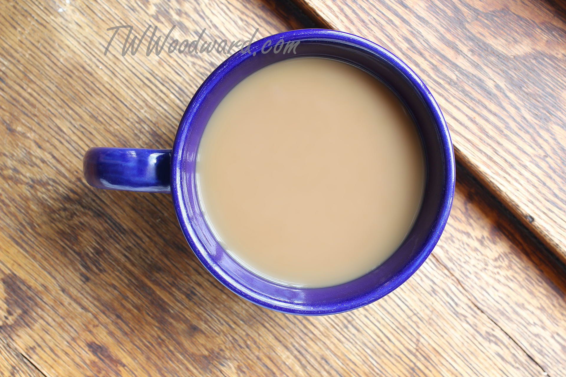 Blue mug sitting beside a journal